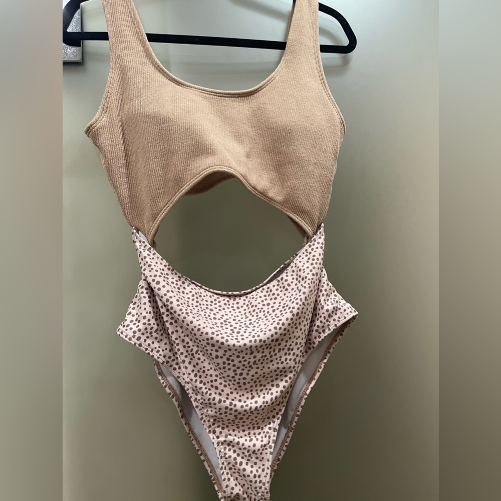 High waisted one piece bathing suit with cut out. High compress on the tummy.